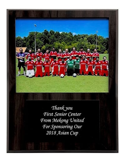 Team photo of Mekong United with a thank you plaque