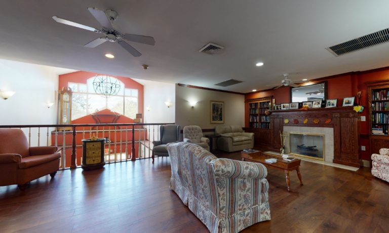 Bright common area with seating and bookshelves