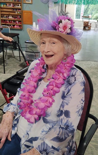 Resident wearing a flower hat and lei
