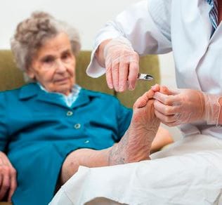 Sarah Adult Day Services, nursing home — Foot care treatment for an elderly woman