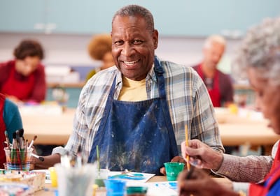 Sarah Adult Day Services, nursing home — Seniors engaged in painting activities in an art studio
