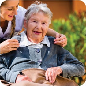 Sarah Adult Day Services, nursing home — Senior caregiver assisting an elderly woman outdoors