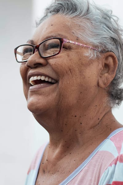 Sarah Adult Day Services, nursing home — Smiling elderly woman with glasses and gray hair