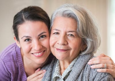 Sarah Adult Day Services, nursing home — Woman with gray hair smiling with younger woman beside her