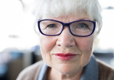 Sarah Adult Day Services, nursing home — Close-up portrait of an elderly woman with glasses