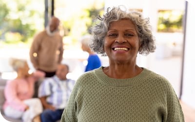 Serenity Adult Day Health II, adult day care in Warner Robins, GA — Smiling senior woman in a cheerful activity space