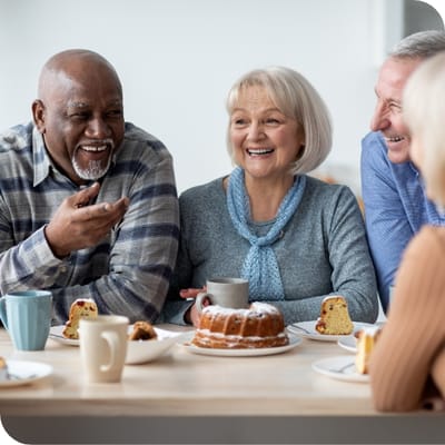 Serenity Adult Day Health II, adult day care in Warner Robins, GA — Seniors enjoying tea and cake in a cheerful dining setting