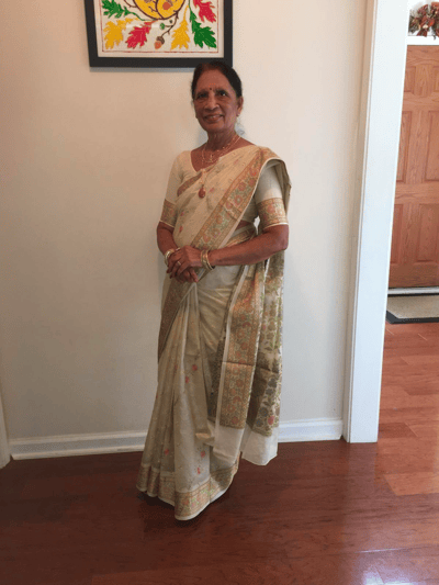 A resident dressed in traditional attire in a bright interior