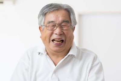 Sarah Adult Day Services, nursing home — Smiling senior man wearing glasses in a light room