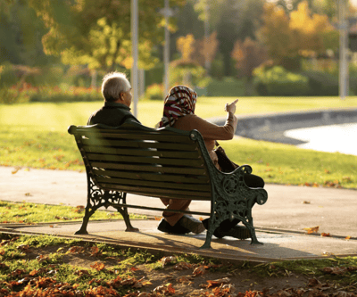 Sarah Adult Day Services, nursing home — Couple sitting on a park bench by a lake
