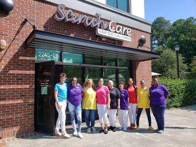 Sarah Adult Day Services, nursing home — Staff members wearing colorful shirts outside a facility