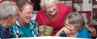 Trinity Care Adult Day Care Center, nursing home — Seniors enjoying laughter and conversation in a communal setting