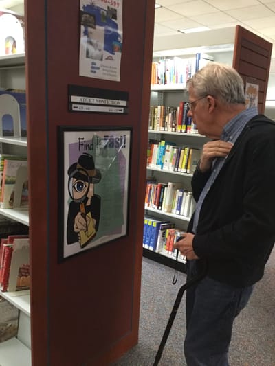Skylark Adh – Johns Creek, home care in Suwanee, GA — Senior man reading a poster in a library