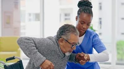 Your Parent’s Place, nursing home — Senior caregiver assisting elderly man with mobility