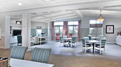 Bright common area with seating and dining tables