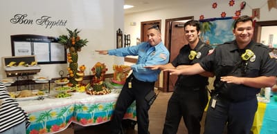 Staff celebrating with a food display in a common area
