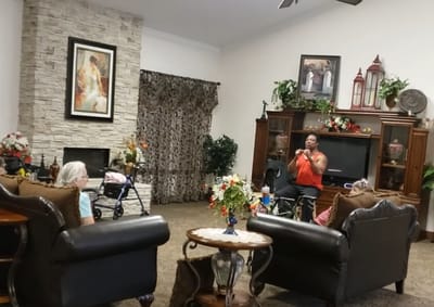 Residents enjoying the common area with a speaker performing