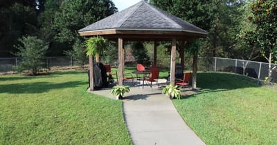 Outdoor gazebo with seating in a green space