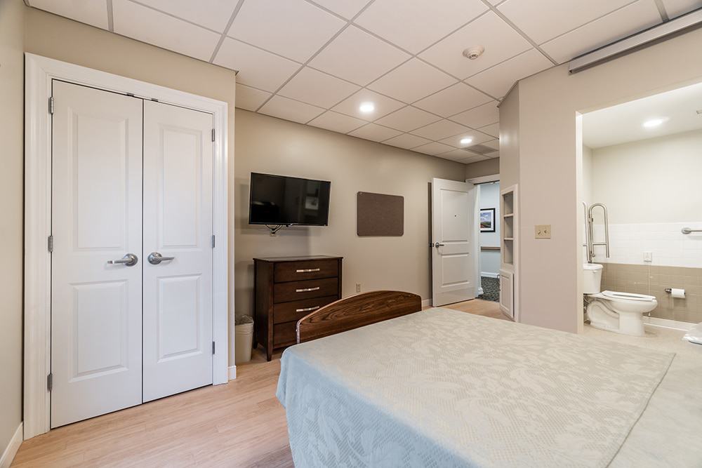 Cozy interior of a resident bedroom with TV and furniture
