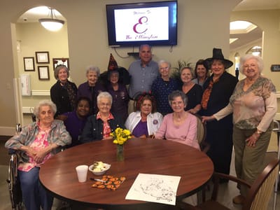 Residents and staff celebrating in the common area