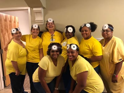 Staff members dressed in fun costumes for an activity