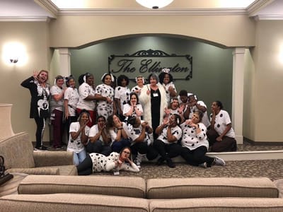 Staff members posing in a celebration at The Ellington