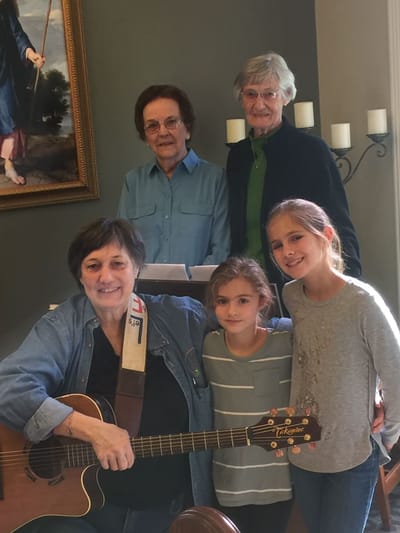 Residents and children enjoying music together indoors
