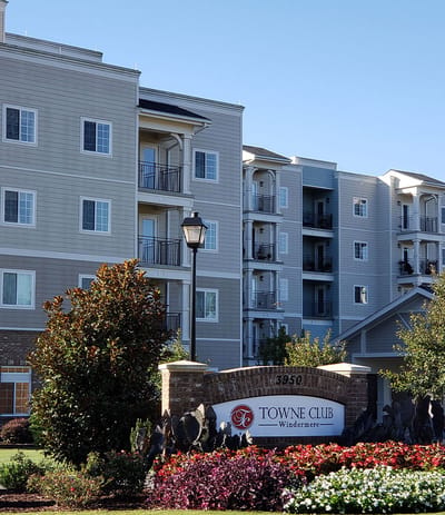 Exterior view of Towne Club Windermere building with landscaping