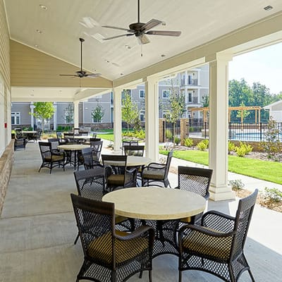 Covered outdoor seating area with tables and chairs