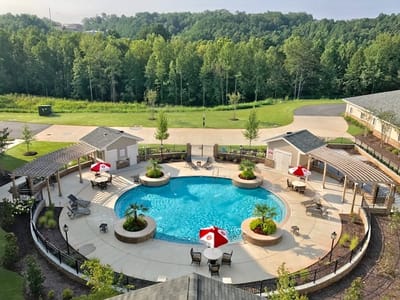 Aerial view of a landscaped pool area with seating