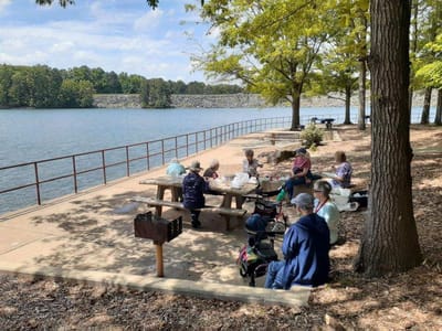 Residents enjoying an outdoor gathering by the lake