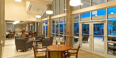 Bright common area with seating and large windows