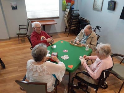 Residents enjoying a card game in a common area