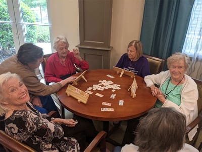 Residents enjoying a game together at a table