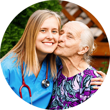 Carrollton Nursing & Rehab Ctr, Nursing Home in Carrollton, GA — Nurse and elderly resident sharing a joyful moment