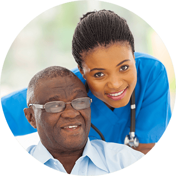 Carrollton Nursing & Rehab Ctr, Nursing Home in Carrollton, GA — Smiling caregiver assisting an elderly resident in a bright environment
