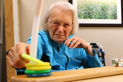 Senior resident engaging in an activity with colorful rings
