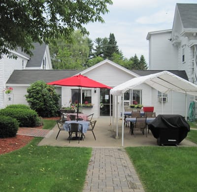 Coastal Manor, Nursing Home in Ludowici, GA — Outdoor patio area with tables and umbrellas