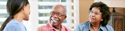 Coastal Manor, Nursing Home in Ludowici, GA — Seniors engaging in conversation with a caregiver