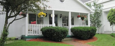 Welcoming entrance with hanging flowers and greenery