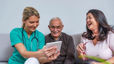 Nurse Care of Buckhead, Nursing Home in Atlanta, GA — Senior caregiver interacting with elderly residents using a tablet