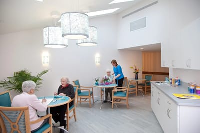 Residents engaged in activities in a bright room