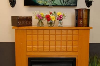 Decorative fireplace in a common area with flowers and books