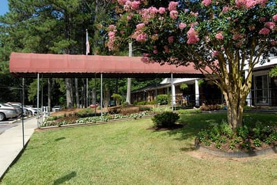 Exterior view of Pine Knoll Nursing & Rehab Center with landscaping