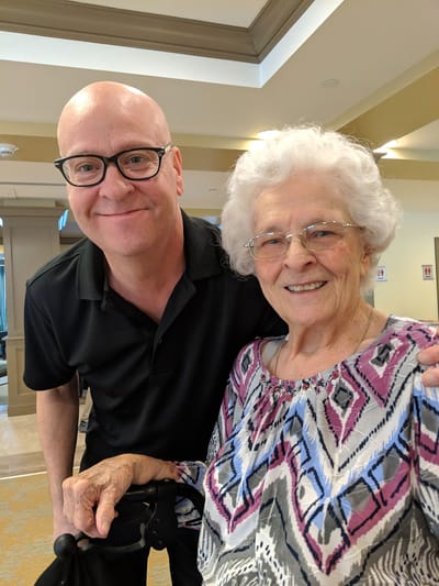 A man and a woman smiling together indoors