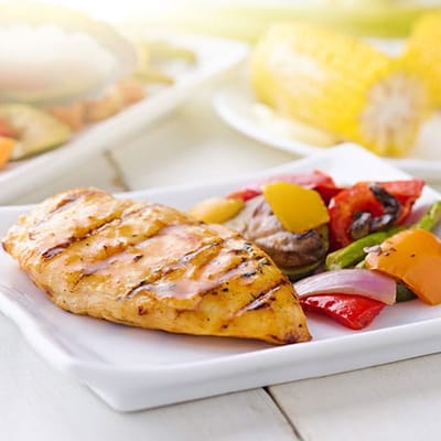 Grilled chicken breast with vegetables on a plate