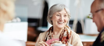 Senior resident smiling while playing cards