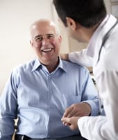 Twin Oaks Convalescent Center, Nursing Home in Alma, GA — Smiling senior man interacting with a healthcare professional