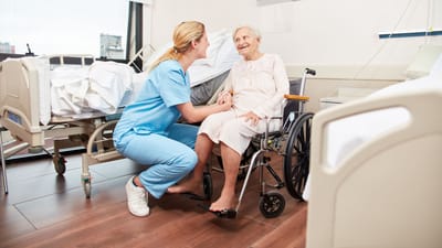 Nurse Care of Buckhead, Nursing Home in Atlanta, GA — Caregiver interacting with an elderly woman in a wheelchair
