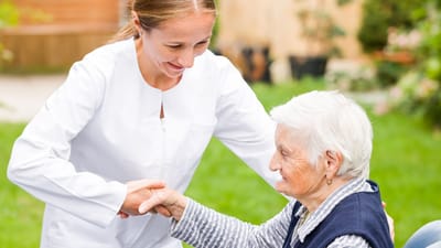Nurse Care of Buckhead, Nursing Home in Atlanta, GA — Nurse assisting an elderly woman in a garden setting